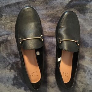 Black loafers with gold bar